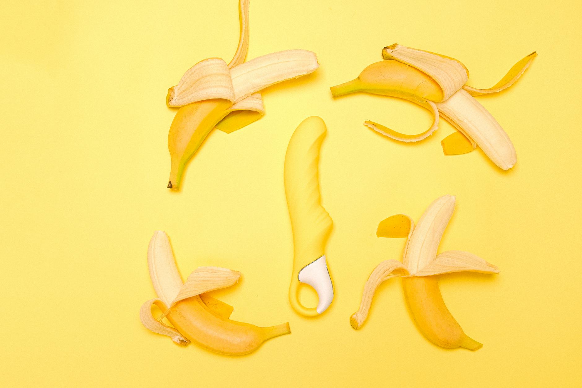 A yellow lemon vibrator surrounded by fresh lemons on a vibrant background