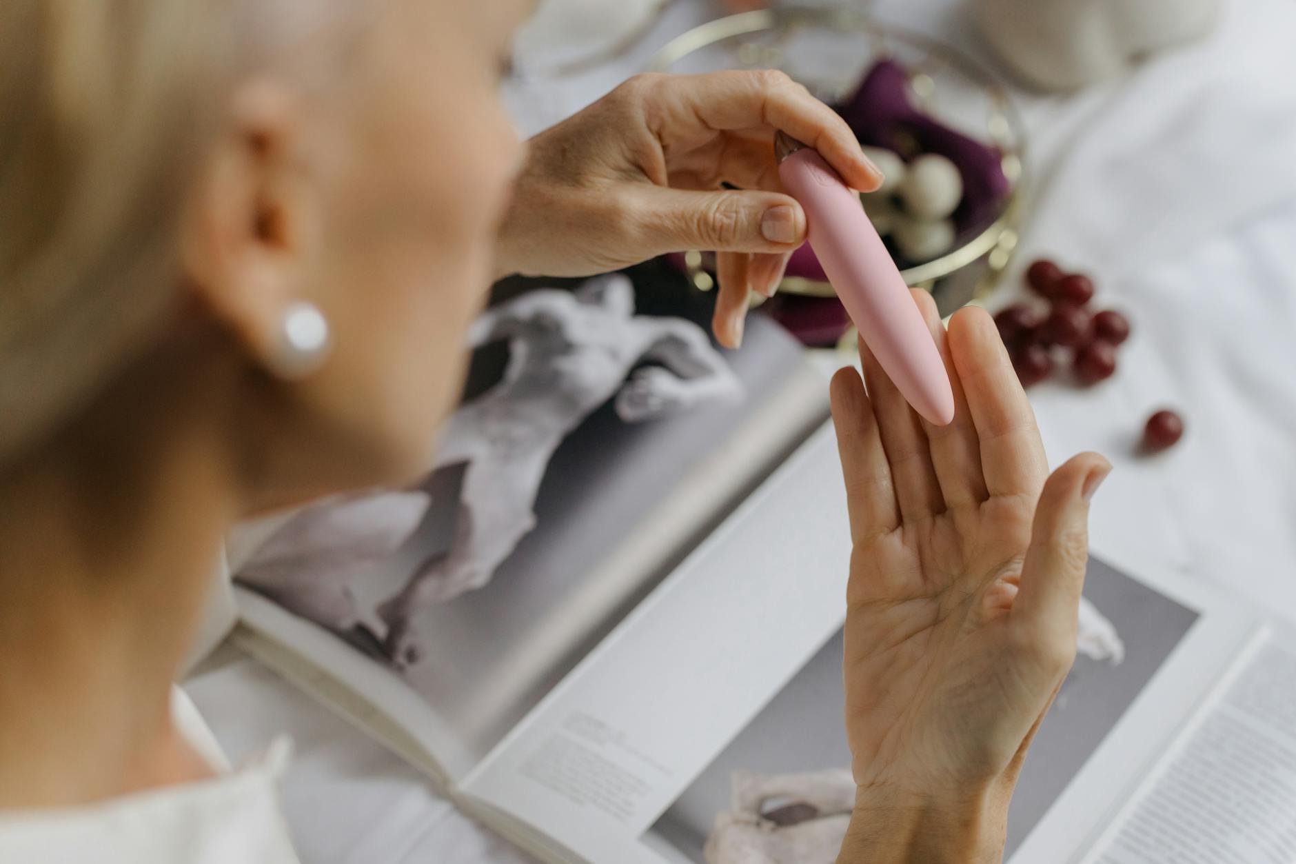 Close-up of a woman holding a lemon-colored vibrator, emphasizing intimate recovery and personal wellness after childbirth.