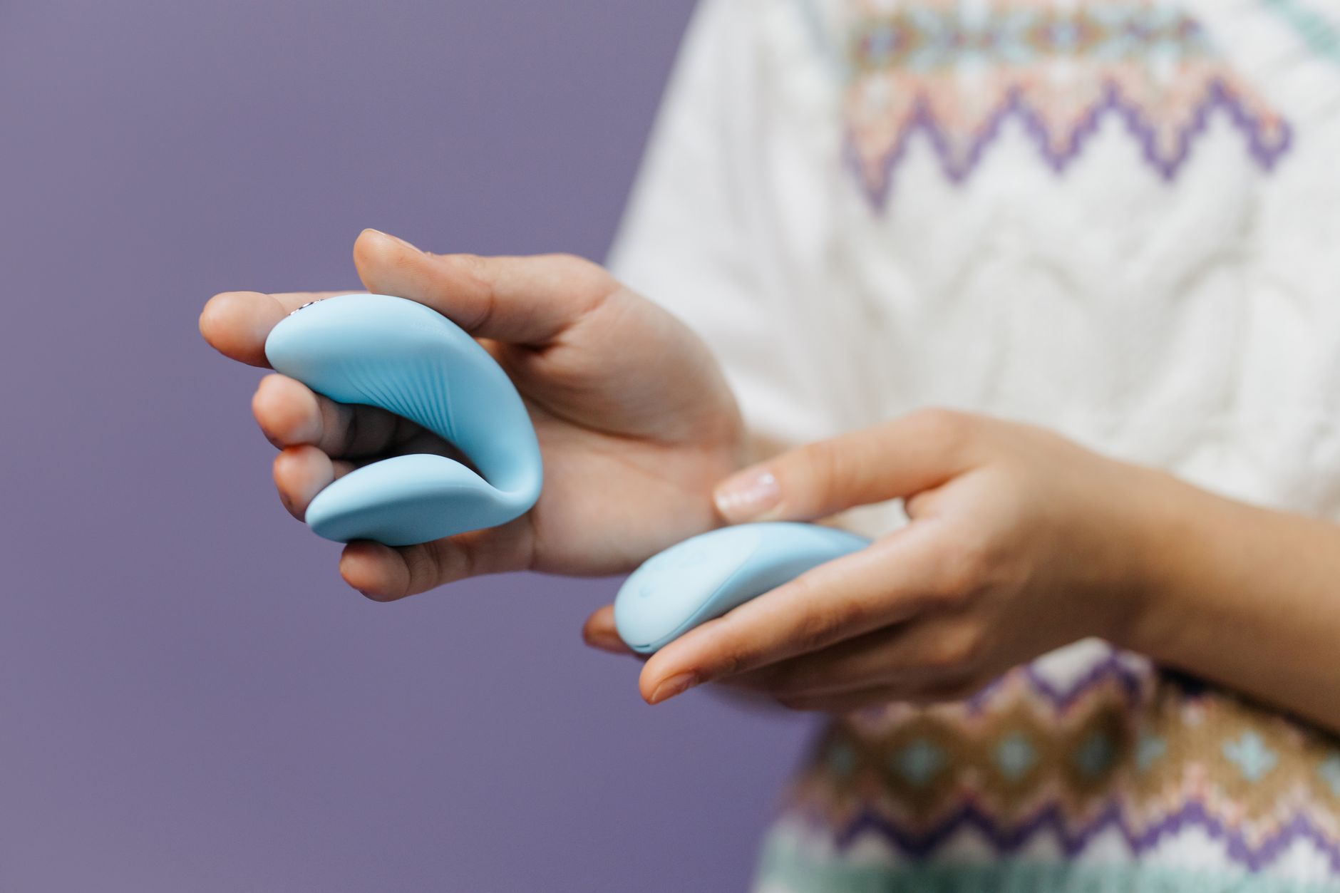 A close-up of hands holding a sleek lemon vibrator, representing reclaiming pleasure without shame